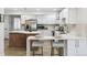 Well-lit kitchen with a large island and white cabinetry at 2430 Eaton St, Edgewater, CO 80214
