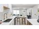 Modern kitchen with white countertops, island seating, and open floor plan at 2430 Eaton St, Edgewater, CO 80214