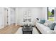 Bright living room featuring light colored walls, hardwood floors, and modern furniture at 2430 Eaton St, Edgewater, CO 80214