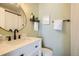 Modern bathroom with a round mirror, white vanity, and updated fixtures at 4481 W 89Th Way, Westminster, CO 80031