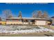 Ranch style home with a snow covered front yard, attached garage, and welcoming porch at 4481 W 89Th Way, Westminster, CO 80031