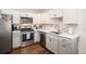 Updated kitchen with white and gray cabinets and stainless steel appliances at 4481 W 89Th Way, Westminster, CO 80031