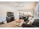 Bright living room features comfy seating, a large TV, and a view into the kitchen at 4481 W 89Th Way, Westminster, CO 80031