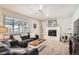 Cozy living room with a fireplace, comfortable seating, and large window at 4481 W 89Th Way, Westminster, CO 80031