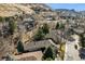 An aerial view of a charming house nestled in a tree-lined neighborhood at 837 Meadow Run, Golden, CO 80403