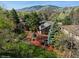 Aerial view of the home, showcasing the beautifully landscaped yard, surrounding trees, and mountain views at 837 Meadow Run, Golden, CO 80403