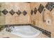 Bathroom boasts a luxurious soaking tub and decorative tiled walls at 837 Meadow Run, Golden, CO 80403