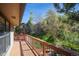 View of wooden deck overlooking greenery and other single Gathering homes at 837 Meadow Run, Golden, CO 80403