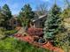 Stunning home with lush landscaping, mature trees and a charming water feature in the front yard at 837 Meadow Run, Golden, CO 80403