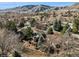 Overhead view of home showing landscaping and mountainous scenery beyond the neighborhood at 837 Meadow Run, Golden, CO 80403