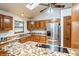 This kitchen features a skylight and modern stainless steel appliances with granite counters at 837 Meadow Run, Golden, CO 80403