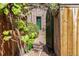 Landscaped backyard with a stone path that leads through the garden gate to the house at 1795 N Monaco St Pkwy, Denver, CO 80224