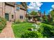 Brick home with a large backyard featuring a patio, green lawn, and meticulous landscaping at 1795 N Monaco St Pkwy, Denver, CO 80224
