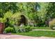 Charming backyard featuring lush greenery and a serene patio seating area at 1795 N Monaco St Pkwy, Denver, CO 80224