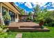 Backyard patio featuring stone pavers, a seating area, lush landscaping, and an inviting ambiance at 1795 N Monaco St Pkwy, Denver, CO 80224