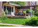 Charming backyard patio with manicured lawn, outdoor seating and awning at 1795 N Monaco St Pkwy, Denver, CO 80224