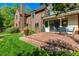 Relaxing backyard patio features stone pavers, outdoor seating and manicured lawn at 1795 N Monaco St Pkwy, Denver, CO 80224