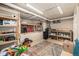 Unfinished basement with storage shelving, a colorful rug, and exposed pipes for future customization at 1795 N Monaco St Pkwy, Denver, CO 80224