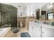 Luxurious bathroom with double vanity, tiled shower, and soaking tub at 1795 N Monaco St Pkwy, Denver, CO 80224