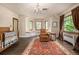 Bedroom with a cozy reading nook, bay windows, hardwood floors, and ample natural light at 1795 N Monaco St Pkwy, Denver, CO 80224