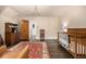 Bright bedroom features a decorative chandelier, hardwood floors, and a charming wooden crib at 1795 N Monaco St Pkwy, Denver, CO 80224