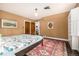Bedroom features large windows, colorful rug, hardwood floors and access to the bath at 1795 N Monaco St Pkwy, Denver, CO 80224