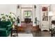 View of dining room through arched doorway, featuring natural light and decorative details at 1795 N Monaco St Pkwy, Denver, CO 80224