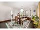 Bright dining room features a large window, hardwood floors, and a decorative chandelier at 1795 N Monaco St Pkwy, Denver, CO 80224