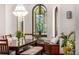 Bright dining room features stained-glass window, a dark wood floor, and a bench at 1795 N Monaco St Pkwy, Denver, CO 80224