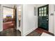 Welcoming entryway boasts a decorative front door, dark wood floors, and views of the living room at 1795 N Monaco St Pkwy, Denver, CO 80224