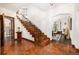 Grand foyer with terracotta tile, arched openings, and a wrought-iron staircase leading to the upper level at 1795 N Monaco St Pkwy, Denver, CO 80224