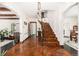 Inviting foyer with terracotta tile flooring, arched doorways, and a wrought iron staircase at 1795 N Monaco St Pkwy, Denver, CO 80224