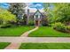 Charming stone Tudor home with a manicured front yard and a stone walkway leading to the front door at 1795 N Monaco St Pkwy, Denver, CO 80224