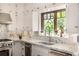 Bright kitchen features white cabinets, stainless steel appliances, and light countertops at 1795 N Monaco St Pkwy, Denver, CO 80224