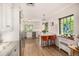 A spacious white kitchen with marble countertops, stainless steel appliances and a breakfast nook at 1795 N Monaco St Pkwy, Denver, CO 80224