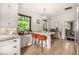 Bright eat-in kitchen boasts a modern island with seating and plenty of natural light at 1795 N Monaco St Pkwy, Denver, CO 80224