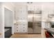 Bright kitchen features white cabinets, stainless steel appliances, and hardwood floors at 1795 N Monaco St Pkwy, Denver, CO 80224