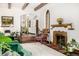 Bright living room featuring a fireplace, arched doorway, and comfortable seating at 1795 N Monaco St Pkwy, Denver, CO 80224