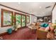 Cozy living room features a large window, wood trim, and a comfortable sectional couch at 1795 N Monaco St Pkwy, Denver, CO 80224