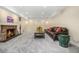 Finished basement living room with a stone fireplace and comfortable seating at 1795 N Monaco St Pkwy, Denver, CO 80224