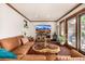 Bright living room features a large window, hardwood floors, and a plush sofa at 1795 N Monaco St Pkwy, Denver, CO 80224
