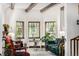 Bright living room featuring beautiful windows with stained glass, a fireplace, and comfortable seating at 1795 N Monaco St Pkwy, Denver, CO 80224