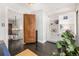 Office with built in shelves and storage and hardwood floors at 1795 N Monaco St Pkwy, Denver, CO 80224
