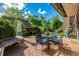Relaxing outdoor patio space with a dining table, bench, and stylish awning at 1795 N Monaco St Pkwy, Denver, CO 80224