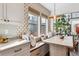 Bright breakfast nook features a built-in bench, elegant lighting, and eye-catching wallpaper at 8461 E 54Th Dr, Denver, CO 80238