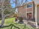 Cozy backyard featuring a small patio, lush lawn, and mature landscaping in a private setting at 13598 E Asbury Dr, Aurora, CO 80014