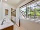 Bathroom featuring a large window and double sinks at 13598 E Asbury Dr, Aurora, CO 80014