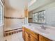 Well-lit bathroom showcasing a double vanity, tiled tub, and natural light at 13598 E Asbury Dr, Aurora, CO 80014