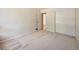 Spacious bedroom with neutral carpet, closet, and an open doorway providing ample natural light at 13598 E Asbury Dr, Aurora, CO 80014