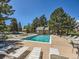 Inviting community pool area with lounge chairs and mature trees, perfect for relaxation at 13598 E Asbury Dr, Aurora, CO 80014